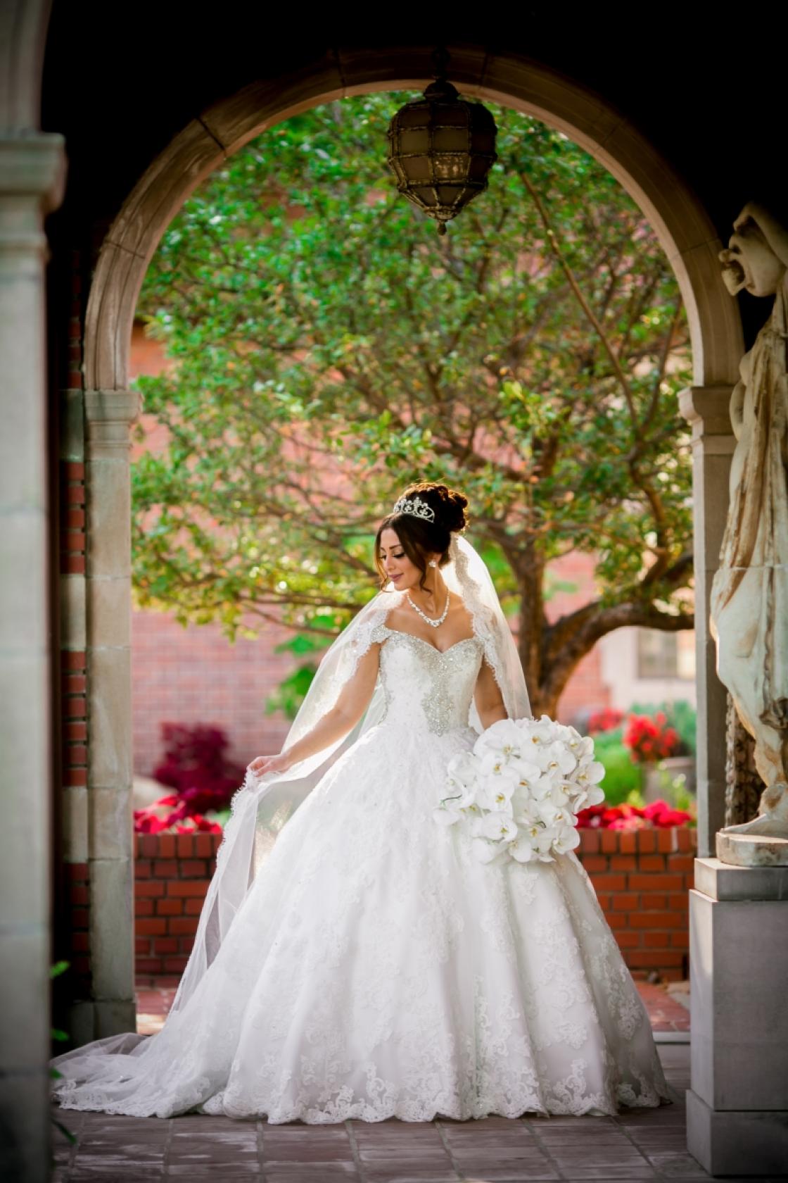 Photograph of a bride in the Cranbrook House Courtyard by FutureWave Images.