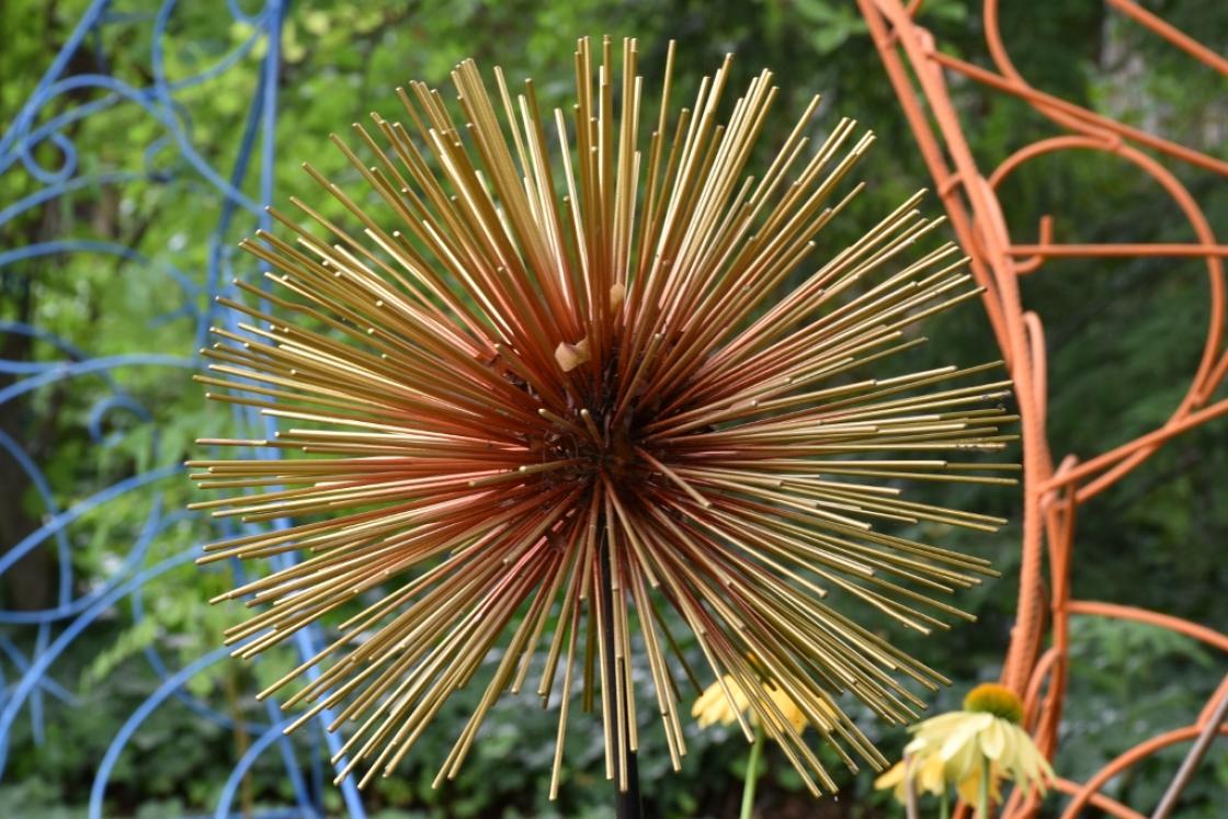 Photograph of abstract artwork in a garden.