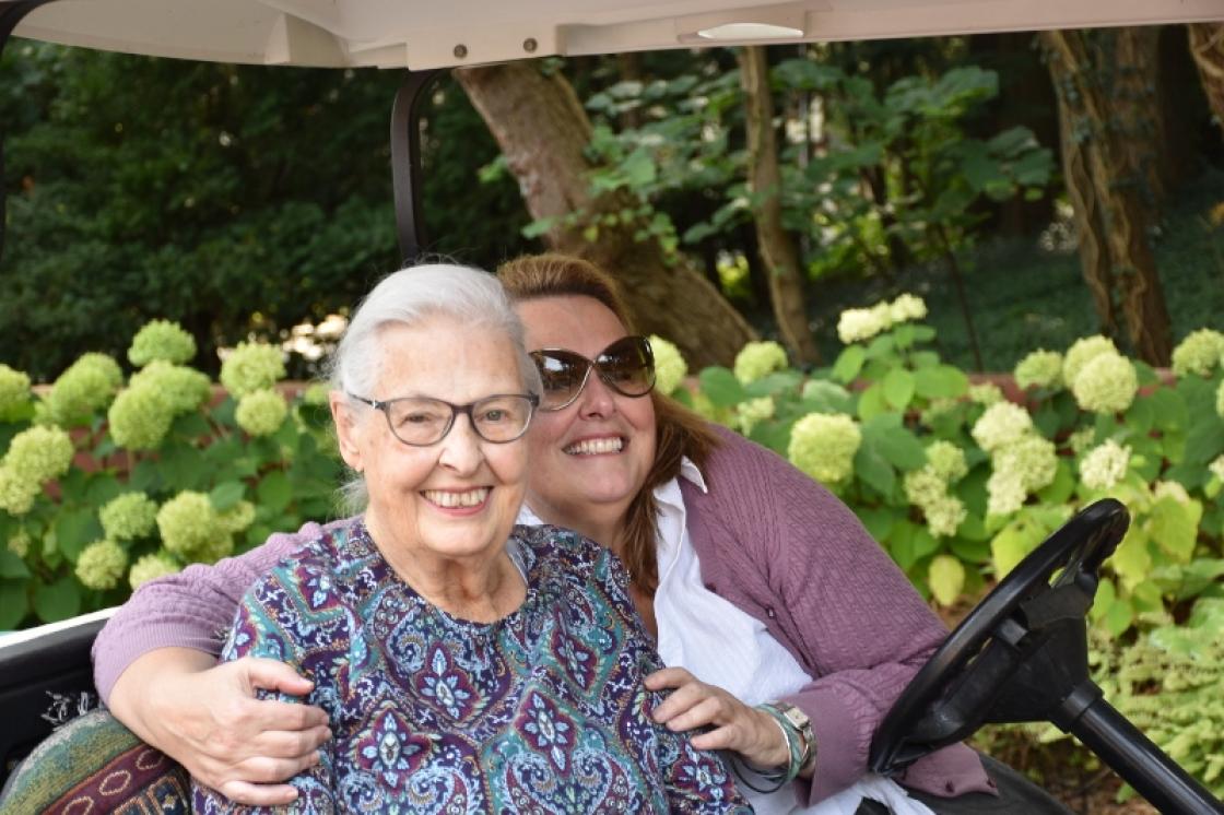Photograph of a mother and daughter hugging at Cranbrook House & Gardens.