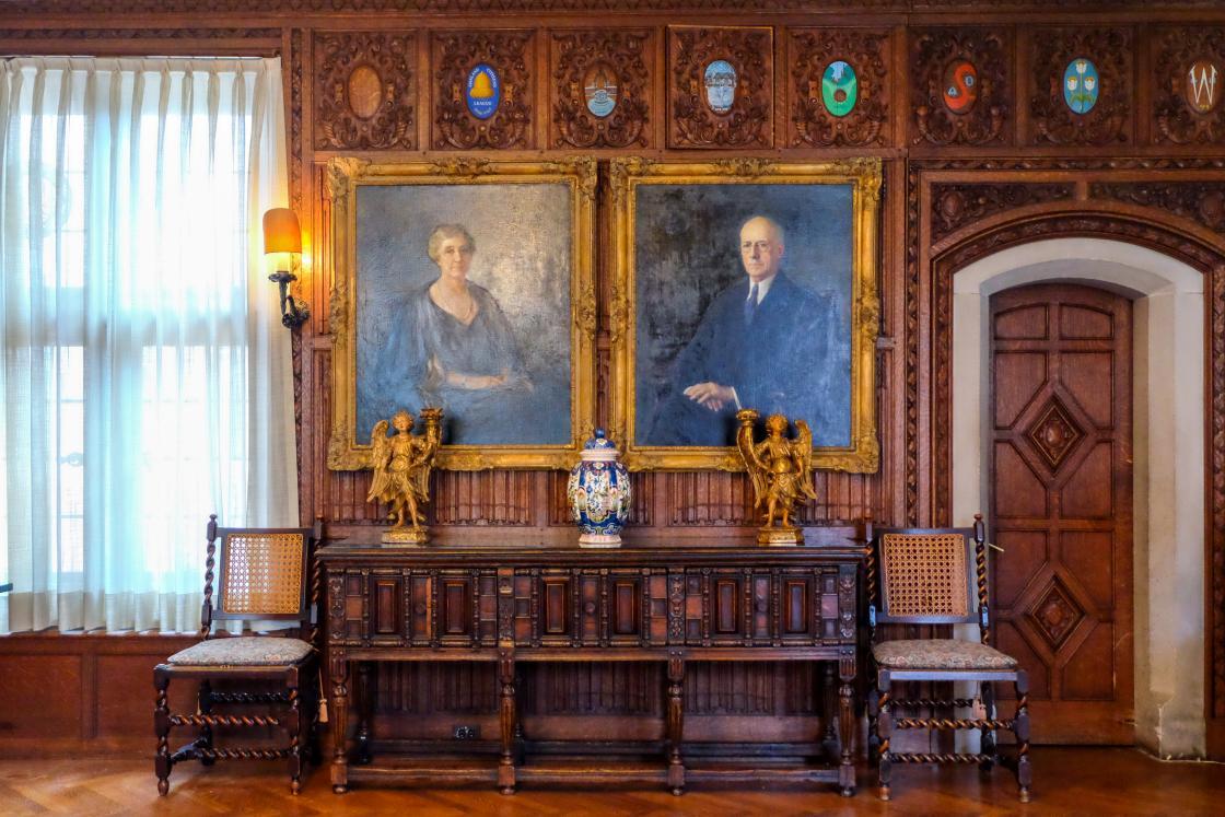Photograph of portraits of George and Ellen Booth in the Cranbrook House Oak Room.