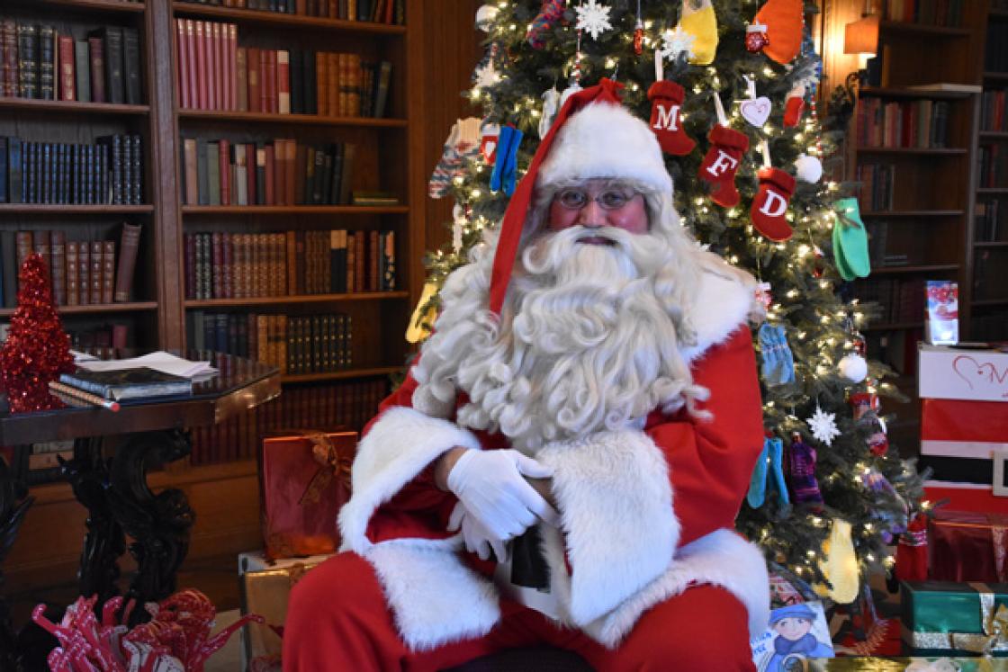 Photograph of Santa Claus in the Cranbrook House Library, December 2019.