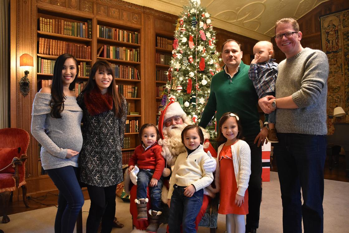 Photograph of a family with Santa during Holiday Splendor at Cranbrook House, December 2018.