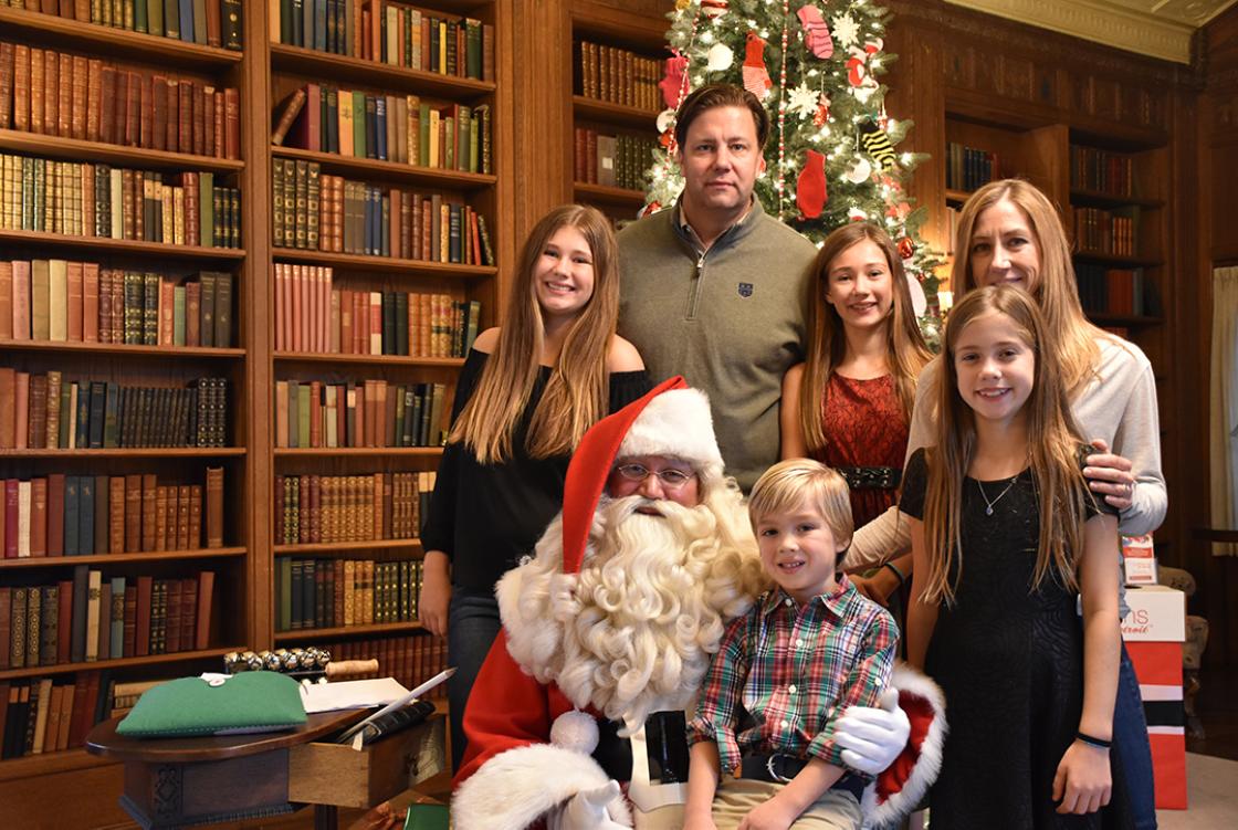 Photograph of a family with Santa during Holiday Splendor at Cranbrook House, December 2018.