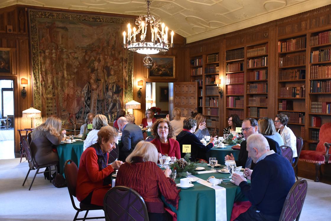 Photograph of guests in the Cranbrook House Library during a tour and holiday luncheon, December 2018.