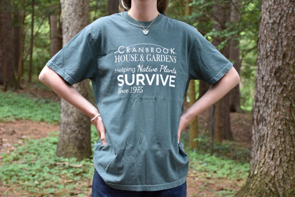 Photo of a model wearing a Cranbrook House & Gardens Native Plant Rescue t-shirt.