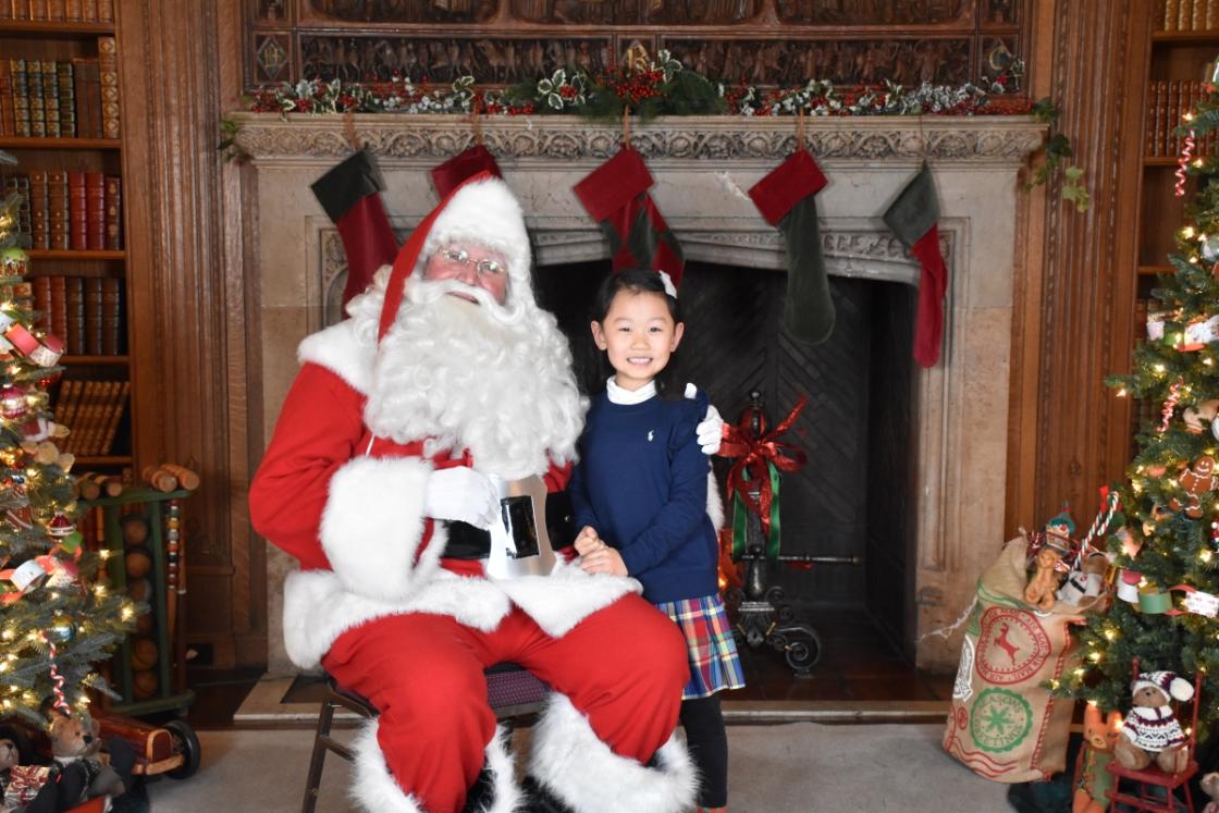 Photo of a family visiting Santa in the Cranbrook House Library.