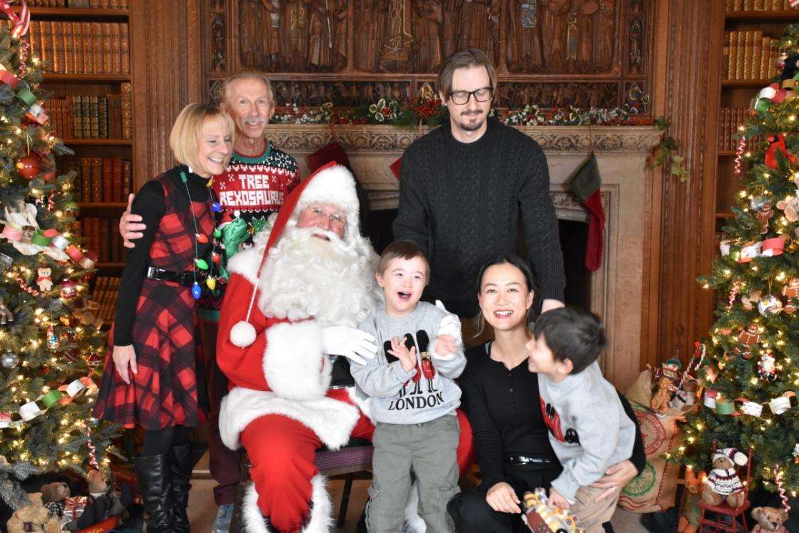 Photo of a family visiting Santa in the Cranbrook House Library.