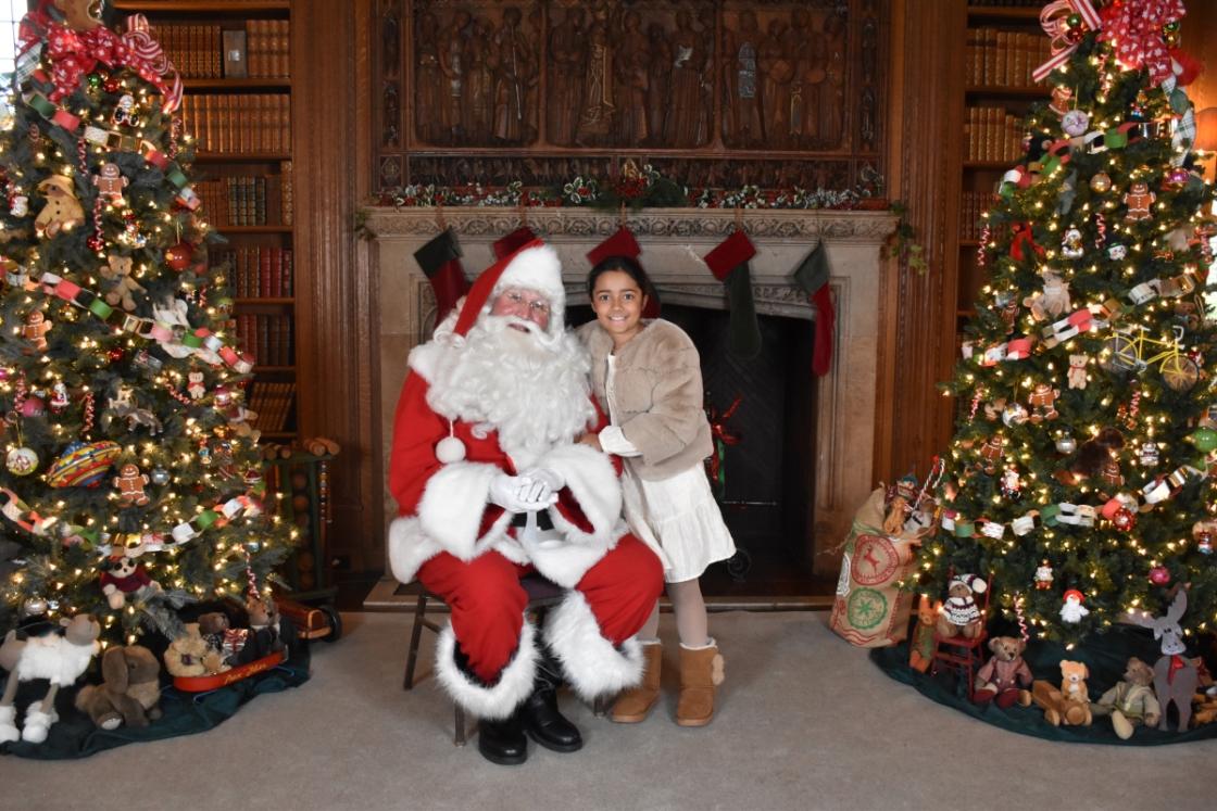 Photo of a family visiting Santa in the Cranbrook House Library.