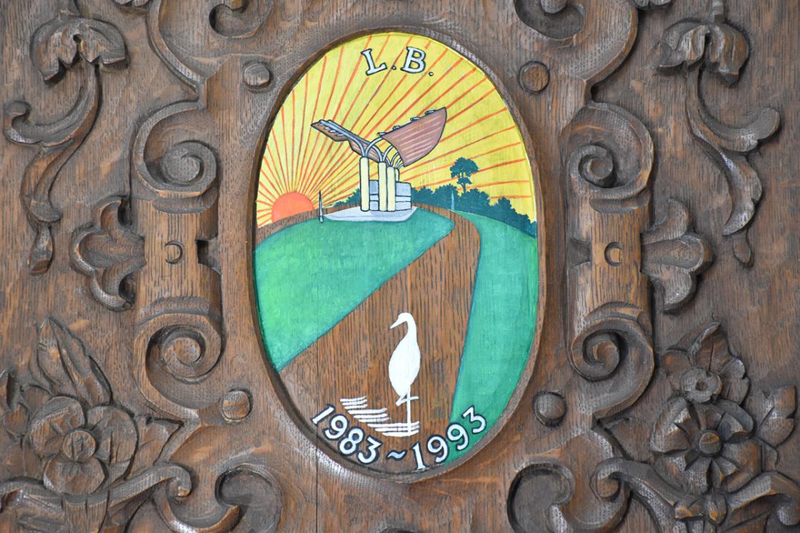 Photograph of the Woodward Entrance cartouche in the Cranbrook House Oak Room.