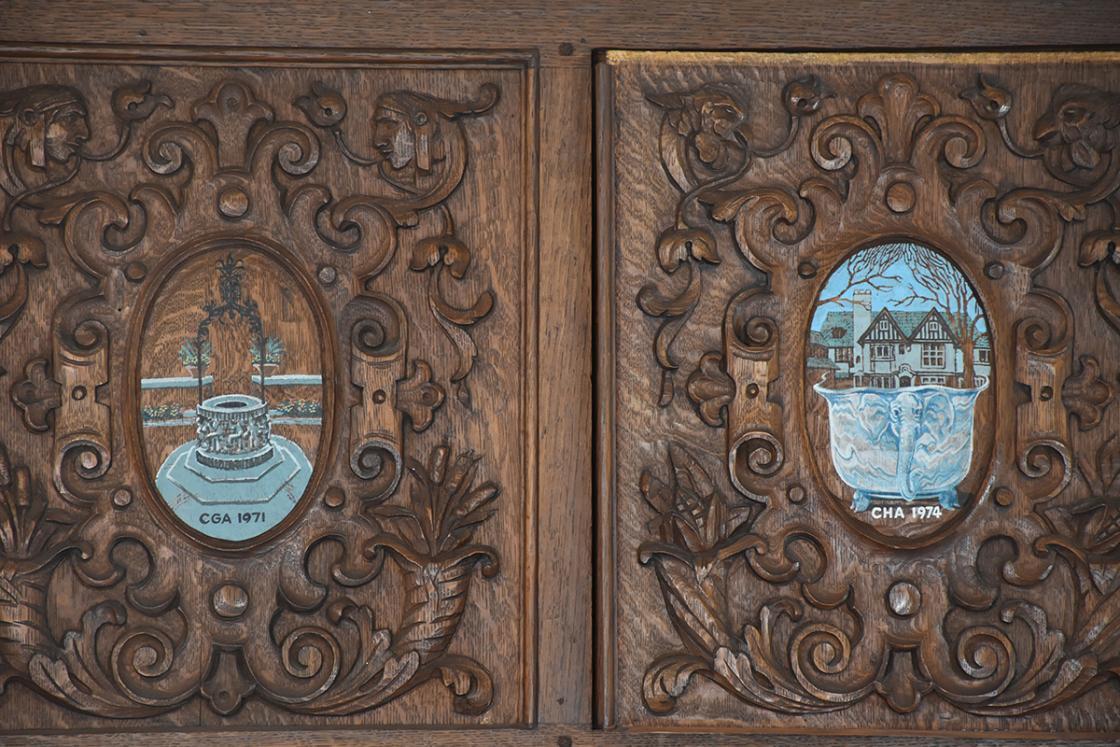 Photograph of cartouches for Cranbrook Gardens Auxiliary and Cranbrook House Auxiliary in the Cranbrook House Oak Room.