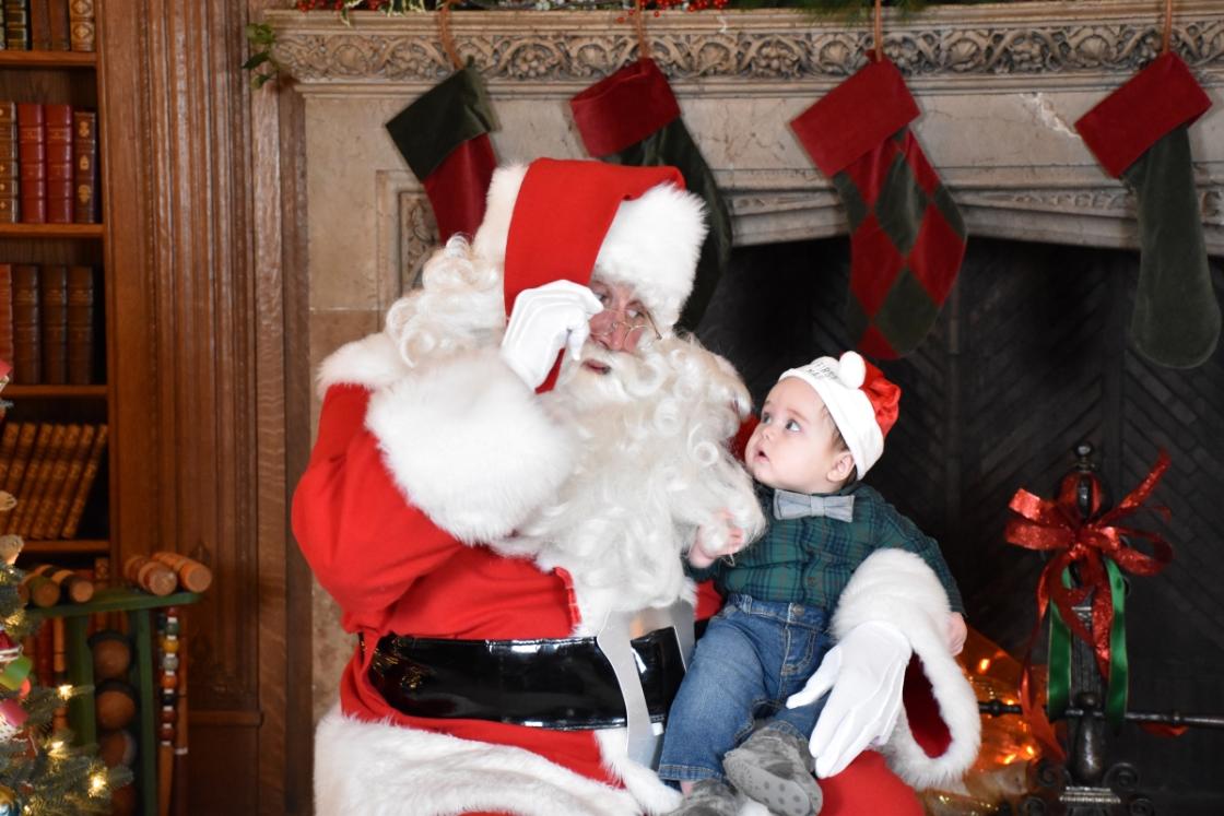 Photo of a family visiting Santa in the Cranbrook House Library.