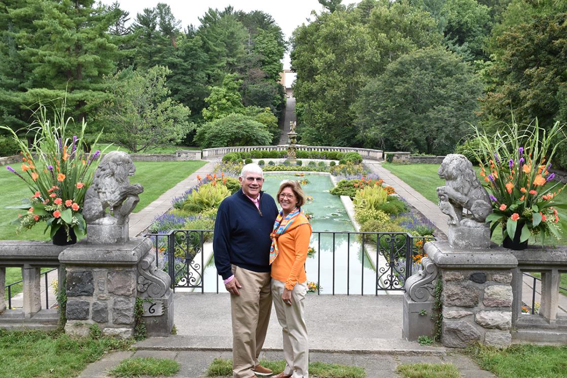 Photograph of a couple standing above the Reflecting Pool at Cranbrook House & Gardens during Art in the Elements, September 2018.