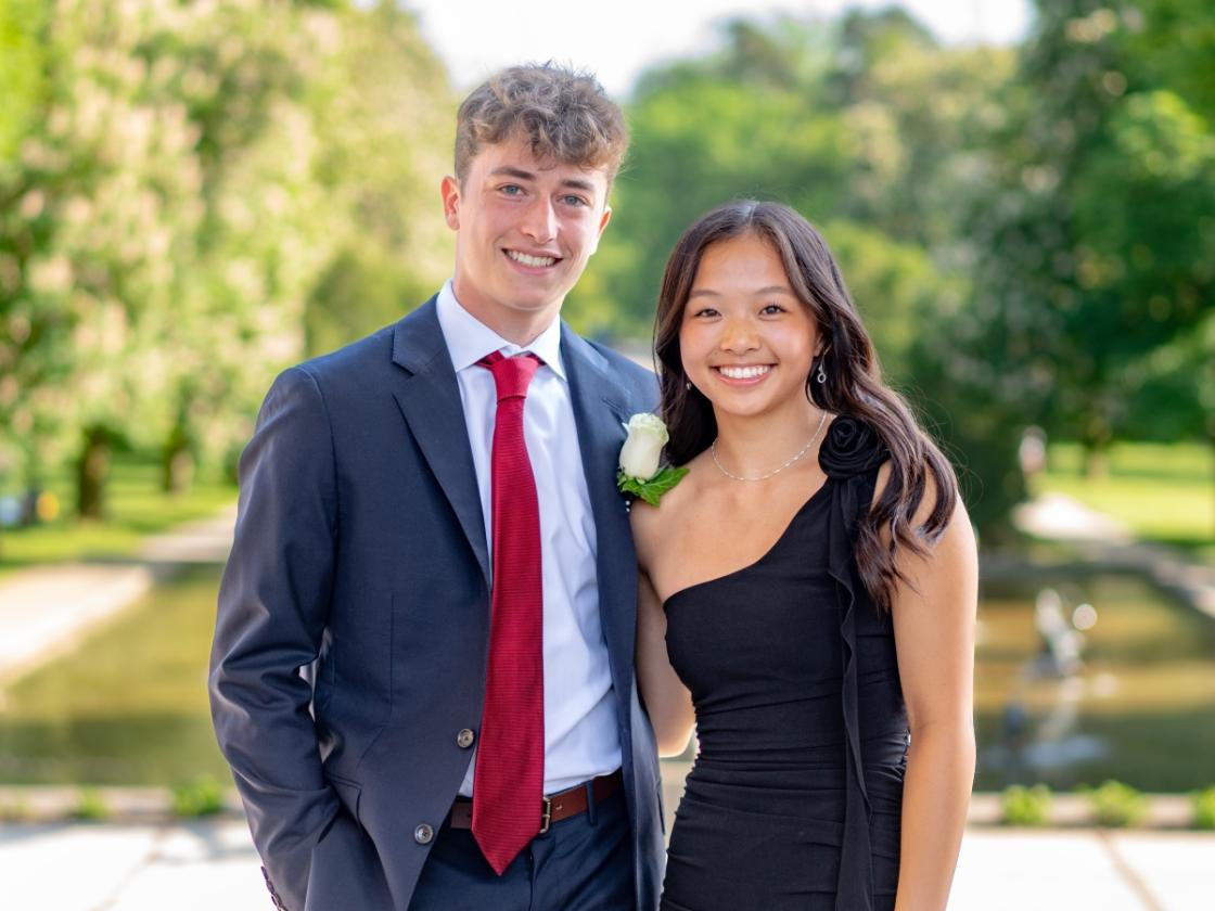 Portrait photo of a couple in front of Triton Pool at Cranbrook Art Museum.